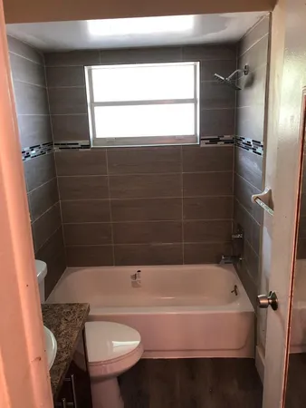 a bathroom with a sink a toilet and bathtub
