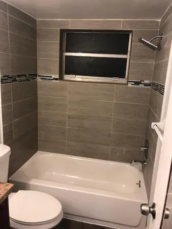 a bathroom with a toilet and a bathtub