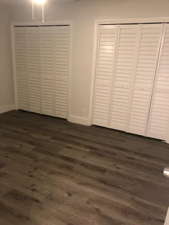 an empty room with wooden floor