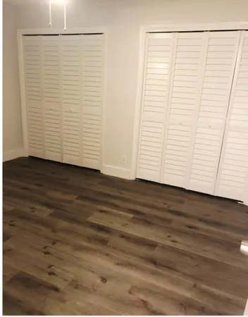 a view of a room with wooden floor