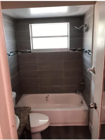 a bathroom with a bathtub and shower