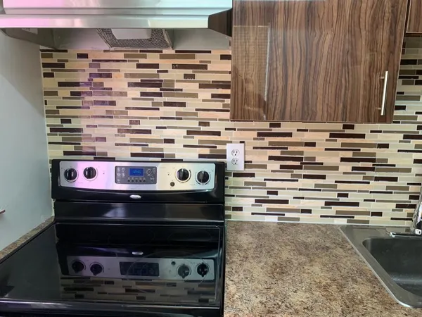 a stove top oven sitting inside of a kitchen