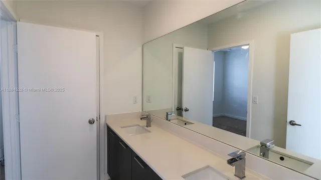 a bathroom with a double vanity sink and a mirror