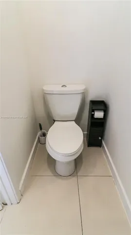 a white toilet sitting next to a white sink