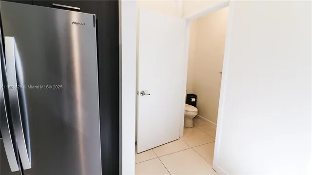 a bathroom with a granite countertop toilet and a sink