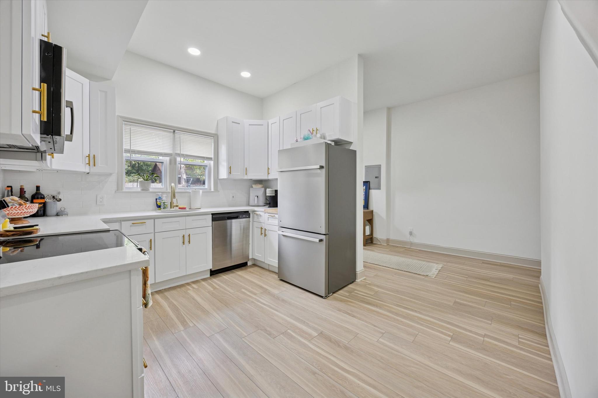 415 North Haddon Avenue, Unit B Haddonfield, NJ 08033 - Photo 1 of 17 a kitchen with a sink a refrigerator and white cabinets