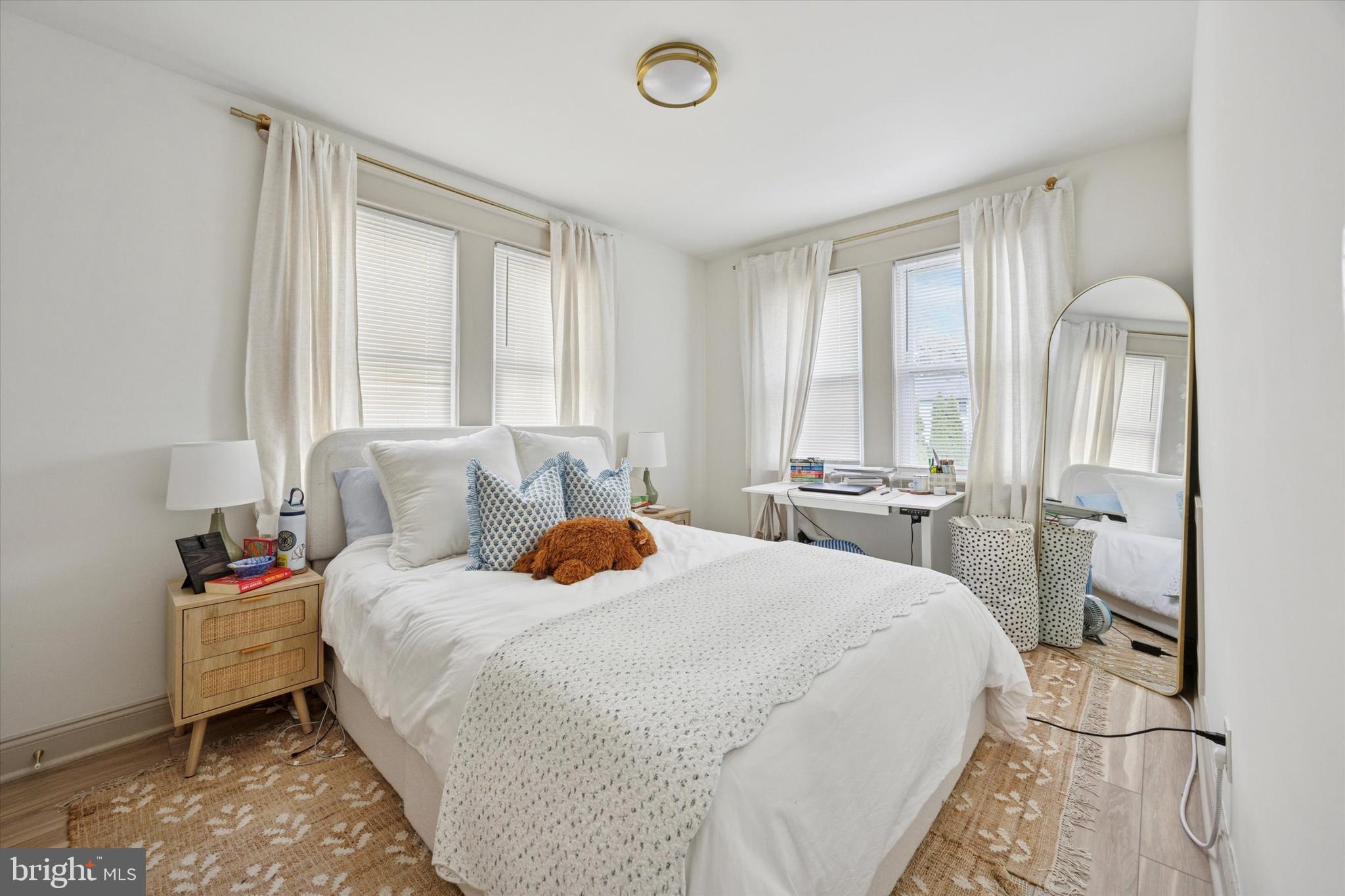 415 North Haddon Avenue, Unit B Haddonfield, NJ 08033 - Photo 11 of 17 a bedroom with a bed and large windows