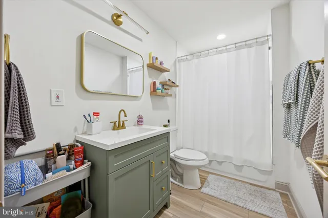 a bathroom with a sink toilet and shower