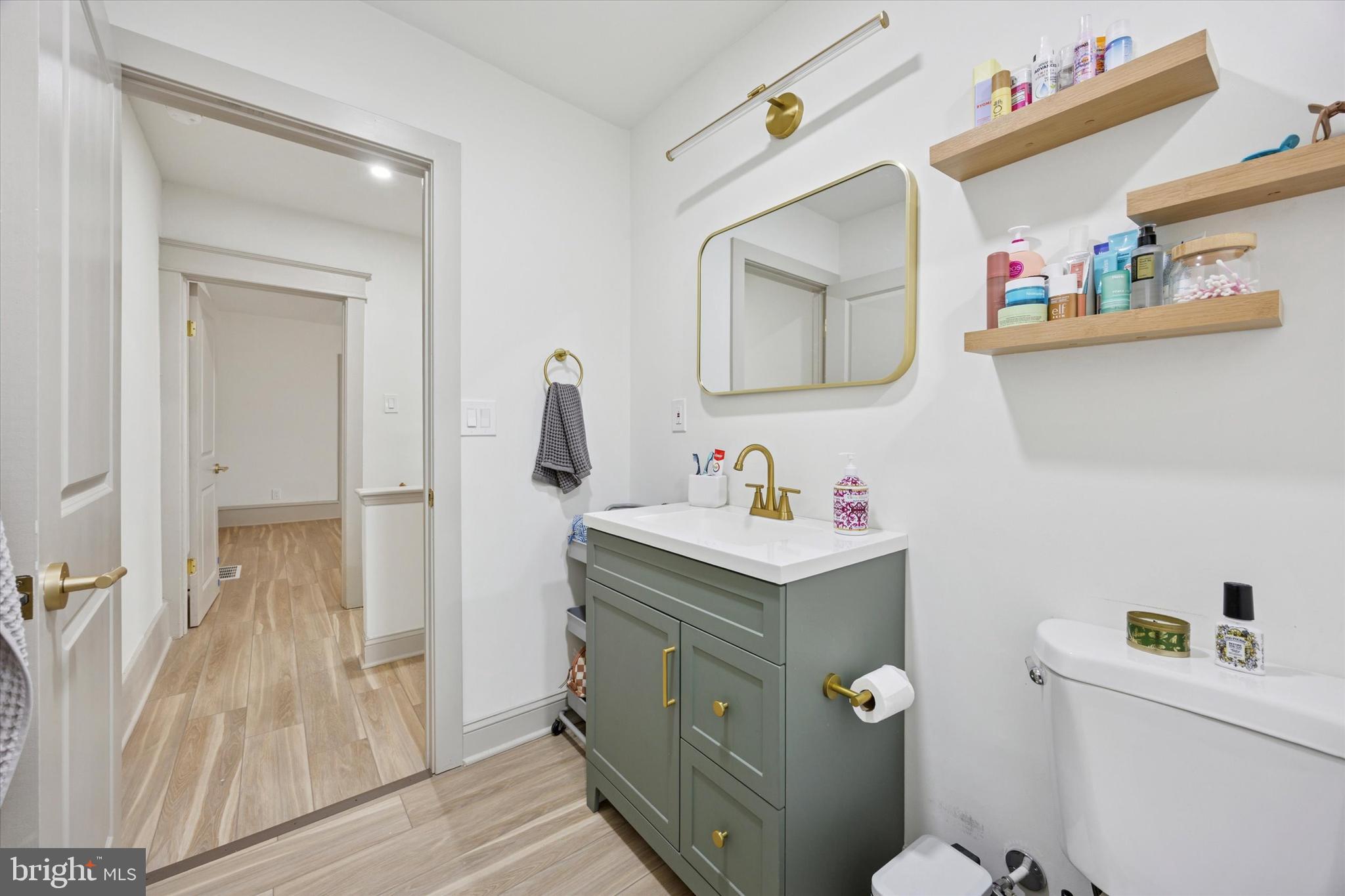 415 North Haddon Avenue, Unit B Haddonfield, NJ 08033 - Photo 14 of 17 a bathroom with a toilet sink and mirror