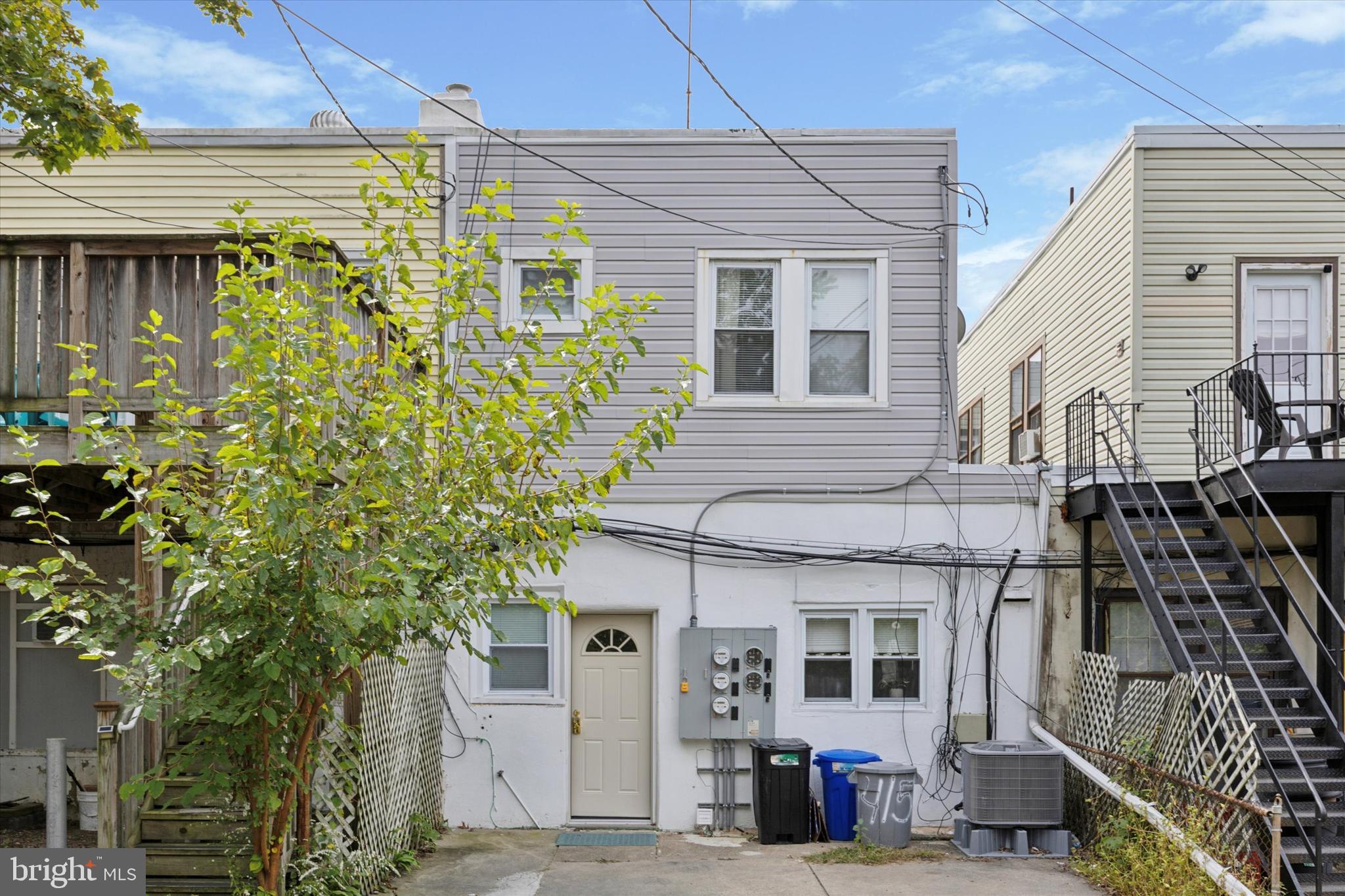 415 North Haddon Avenue, Unit B Haddonfield, NJ 08033 - Photo 15 of 17 a view of a white house with many windows and potted plants
