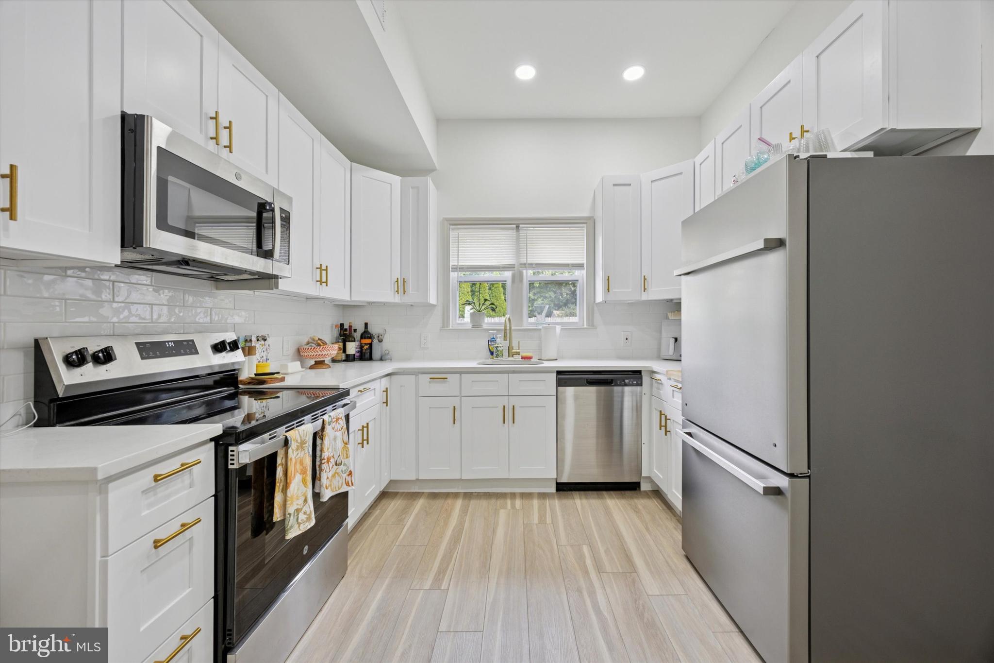415 North Haddon Avenue, Unit B Haddonfield, NJ 08033 - Photo 2 of 17 a kitchen with white cabinets and stainless steel appliances