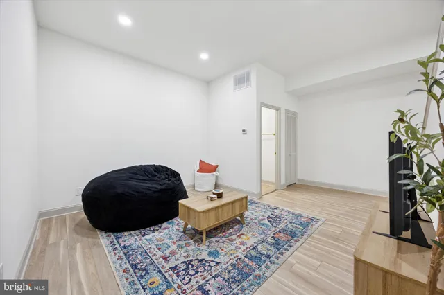 a living room with a couch and a potted plant