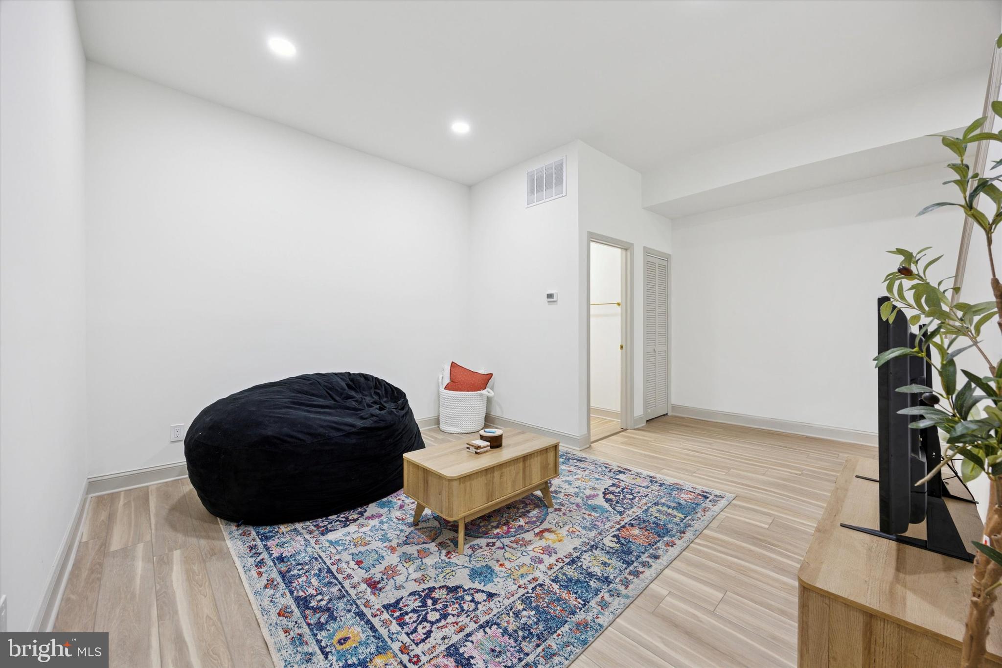 415 North Haddon Avenue, Unit B Haddonfield, NJ 08033 - Photo 6 of 17 a living room with a couch and a potted plant