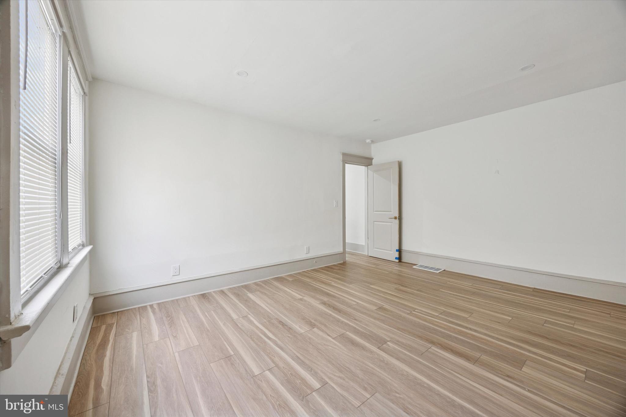415 North Haddon Avenue, Unit B Haddonfield, NJ 08033 - Photo 10 of 17 an empty room with wooden floor and windows