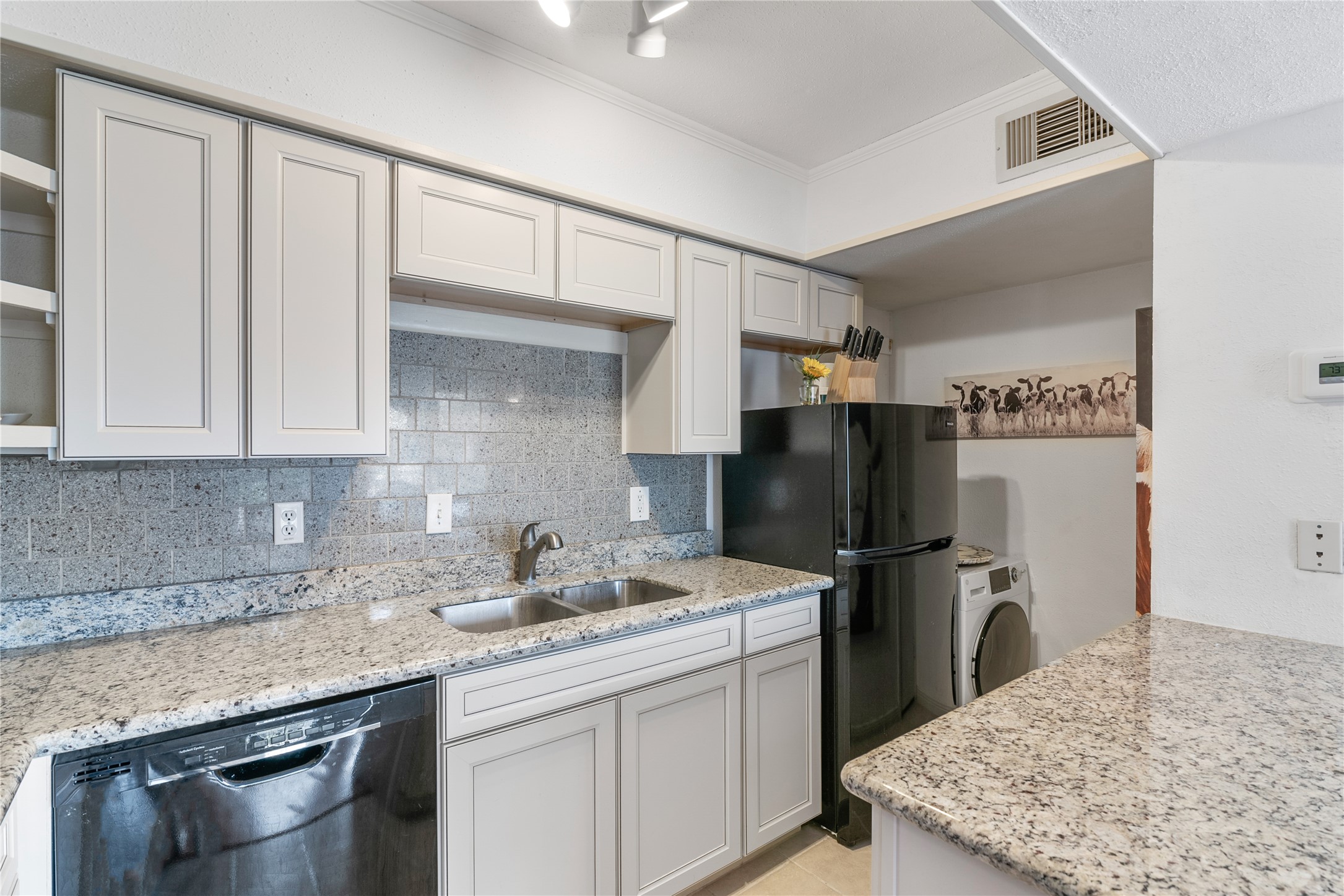 13151 Walden Road, Unit 161 Montgomery, TX 77356 - Photo 5 of 19 Kitchen with a pantry tucked back across from the refrigerator that stays with your new home.