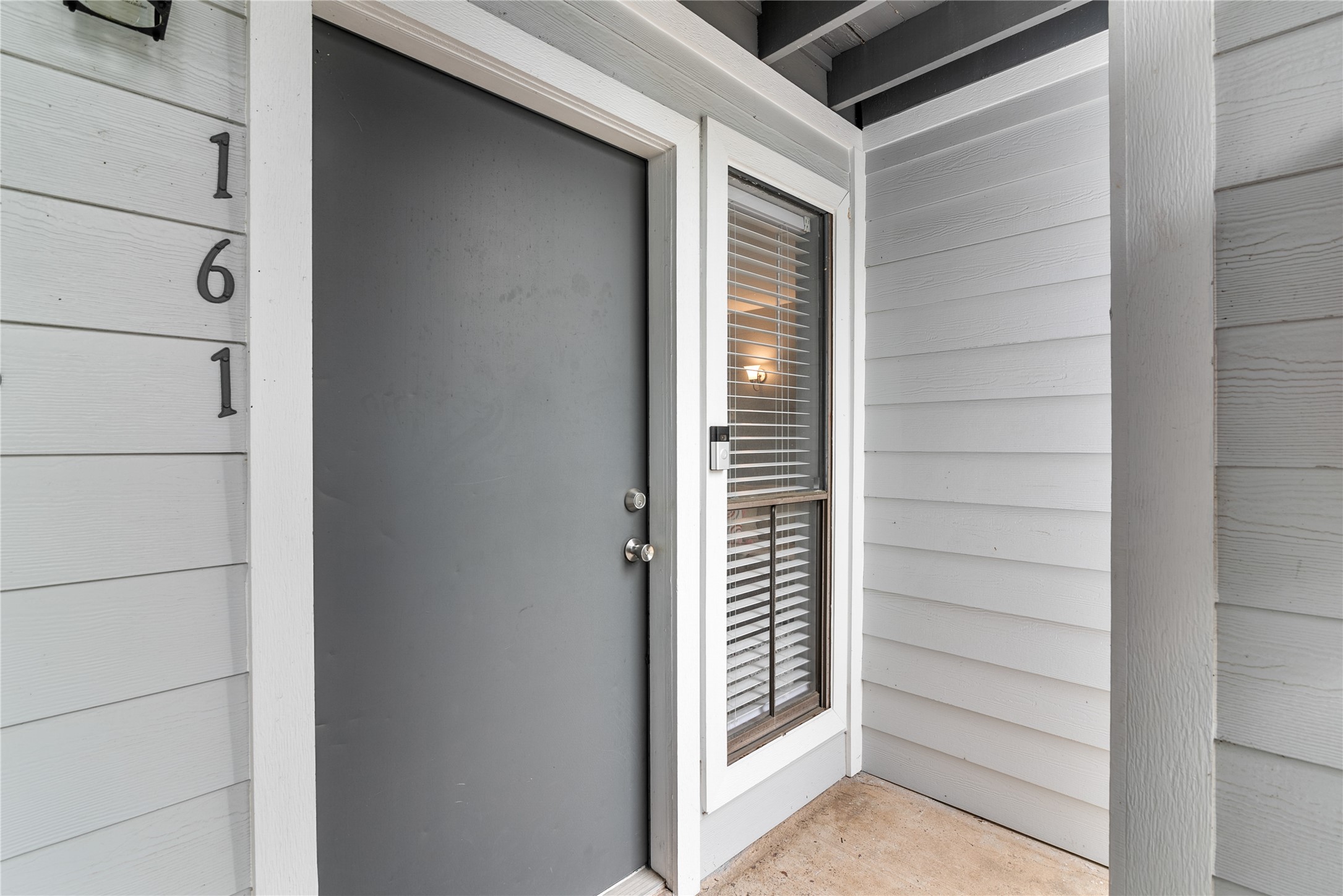 13151 Walden Road, Unit 161 Montgomery, TX 77356 - Photo 8 of 19 Front door is tucked behind a stair case providing extra privacy and a window next to the door.