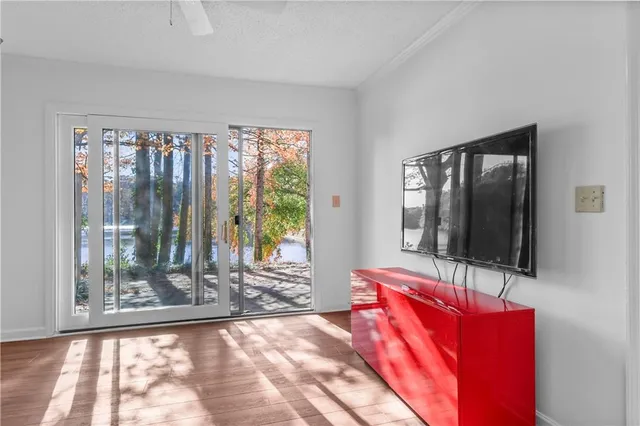 a living room with a large window and a flat screen tv