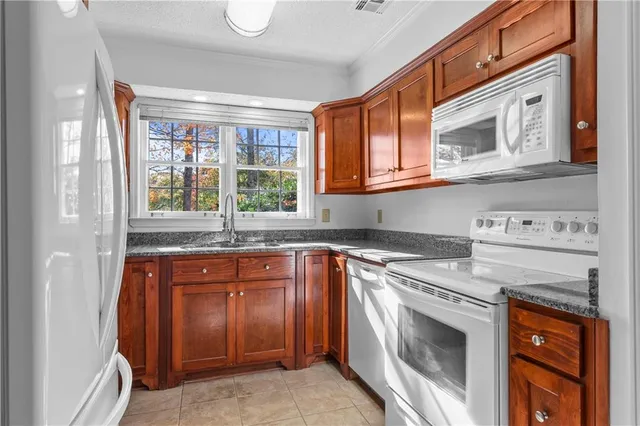 a kitchen with stainless steel appliances granite countertop a stove and a microwave