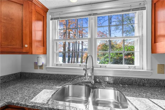 a kitchen with granite countertop a sink and a window