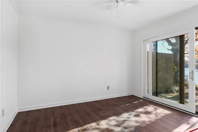a view of a room with wooden floor and windows