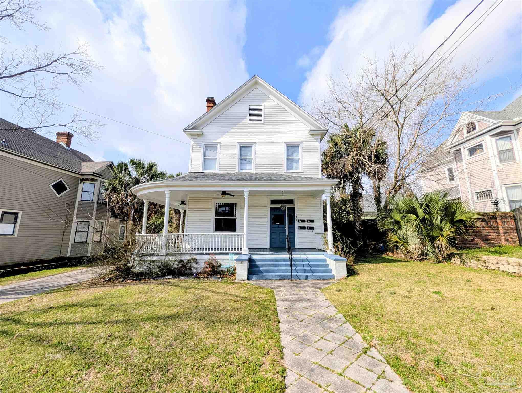a front view of house with yard outdoor seating and barbeque oven