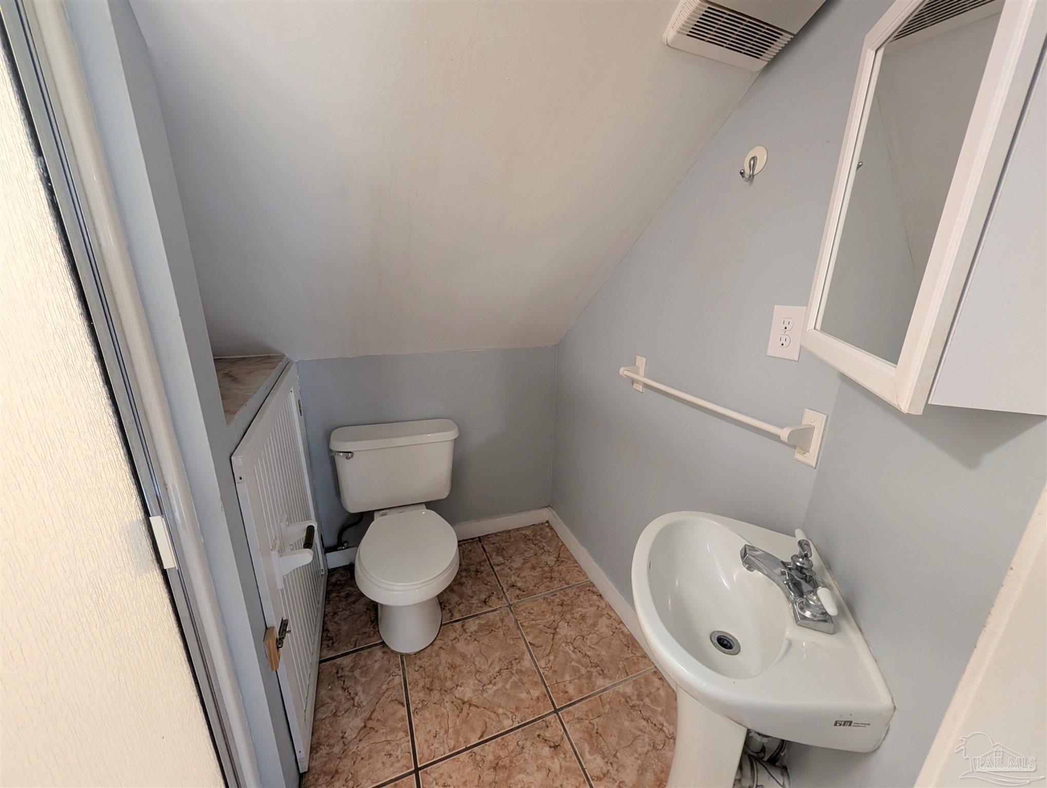 911 North Spring Street, Unit 4 Pensacola, FL 32501 - Photo 13 of 16 a bathroom with a sink and a toilet