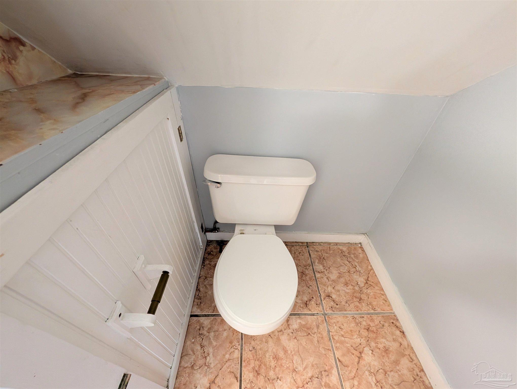 911 North Spring Street, Unit 4 Pensacola, FL 32501 - Photo 14 of 16 a bathroom with a toilet and a mirror