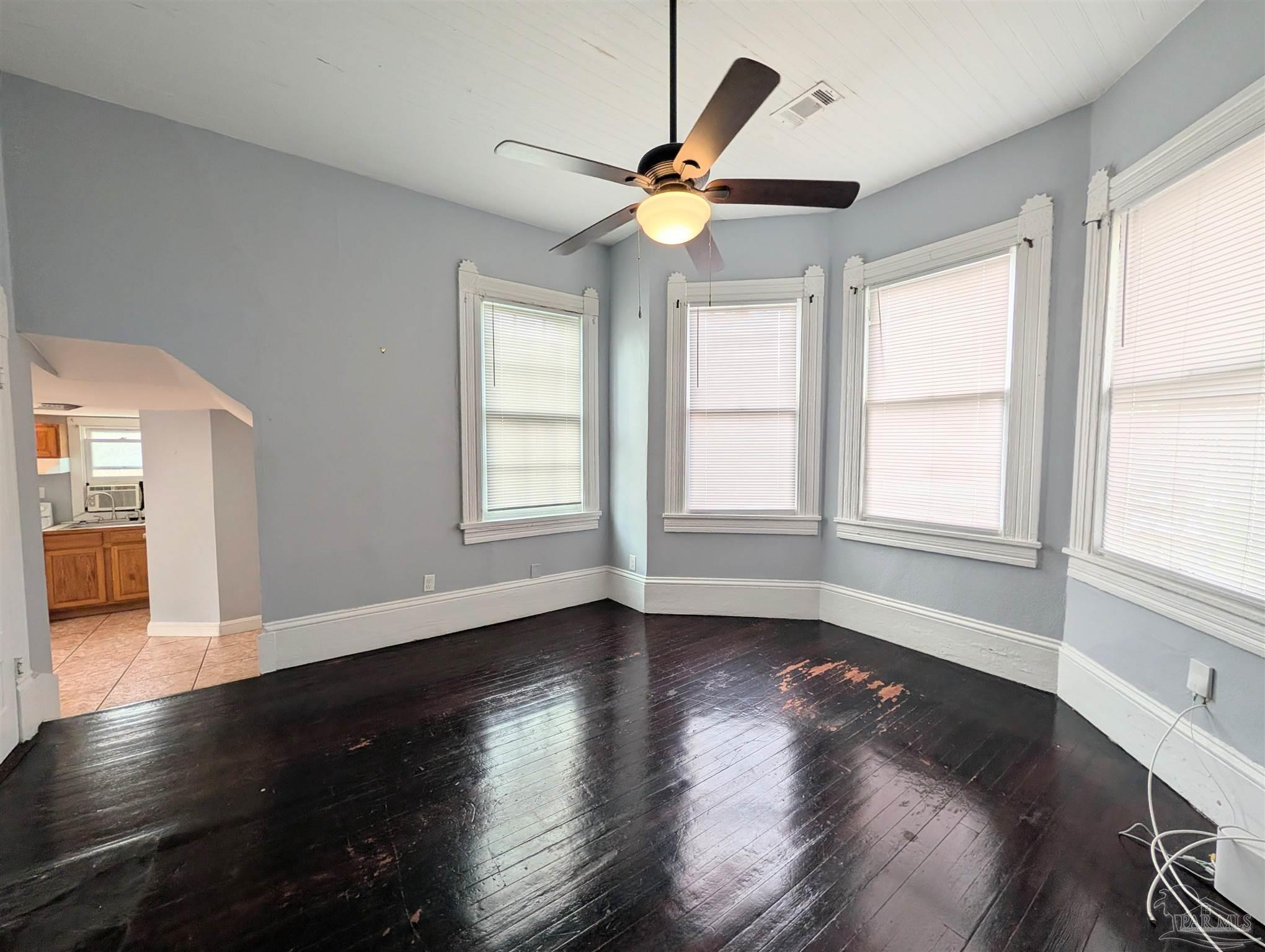 911 North Spring Street, Unit 4 Pensacola, FL 32501 - Photo 5 of 16 a view of an empty room with wooden floor and a window