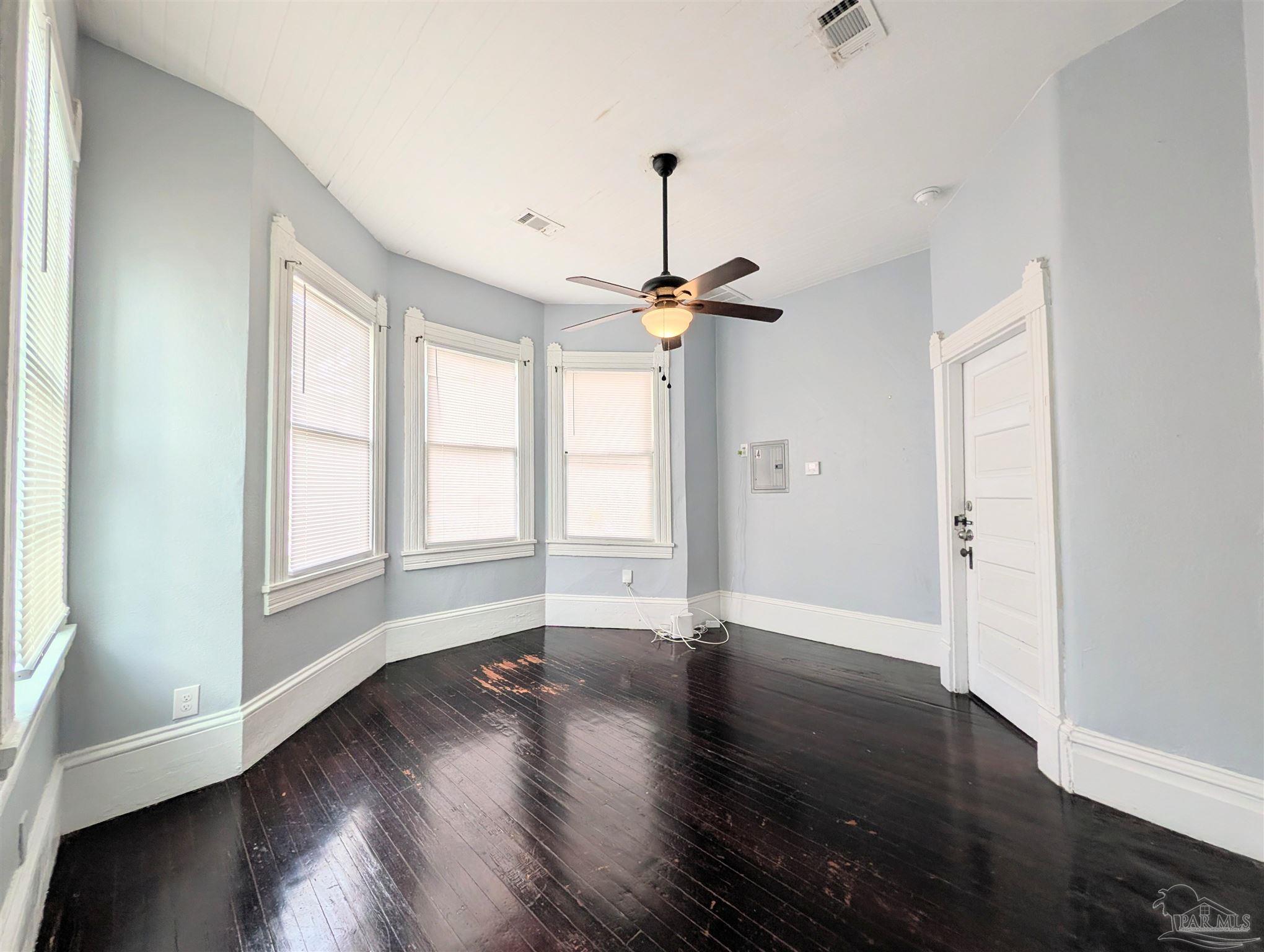 911 North Spring Street, Unit 4 Pensacola, FL 32501 - Photo 6 of 16 wooden floor in an empty room with a window