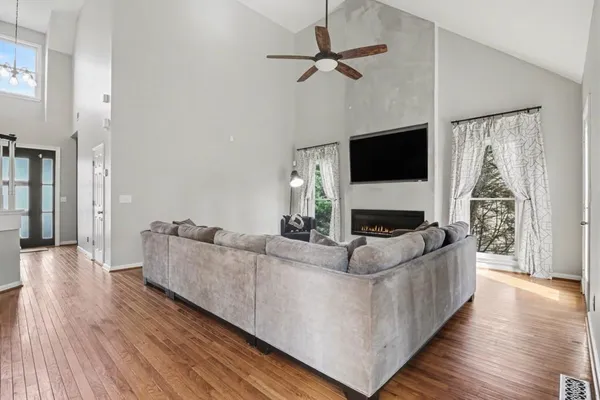a living room with furniture and a flat screen tv