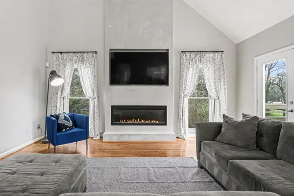 a living room with furniture and a fireplace