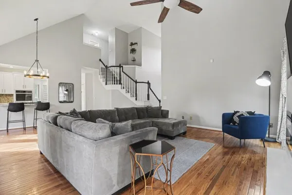 a living room with furniture and a wooden floor