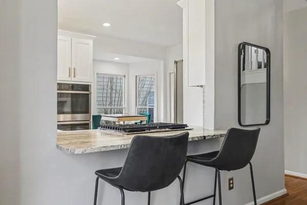 a dining room with table chairs and window