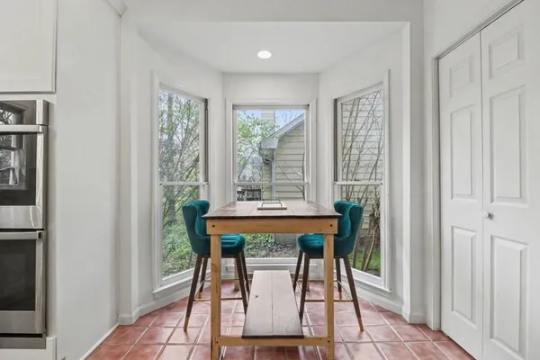 a dining room with furniture and window