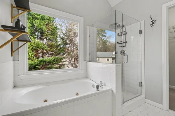 a bathroom with a bathtub and a shower