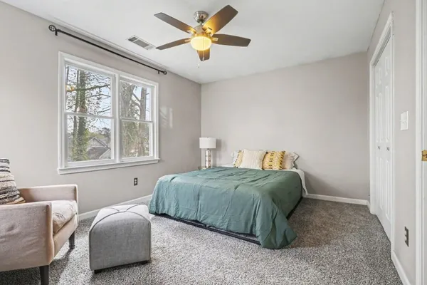 a bedroom with bed and a window