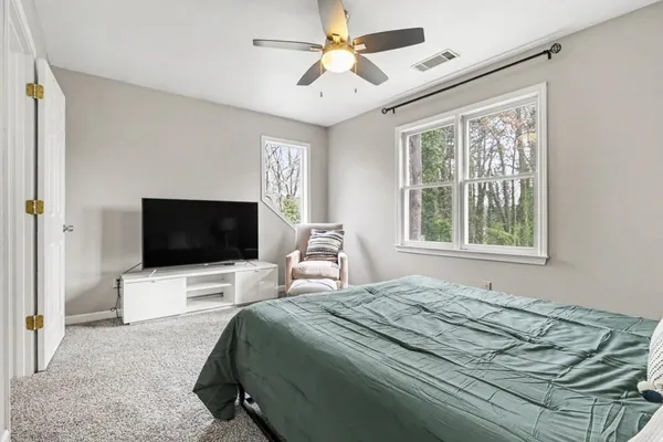 a bedroom with a bed and a flat screen tv