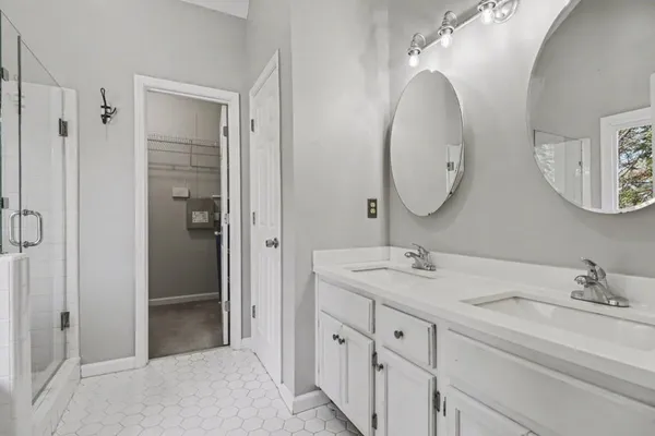 a bathroom with a double vanity sink and a mirror