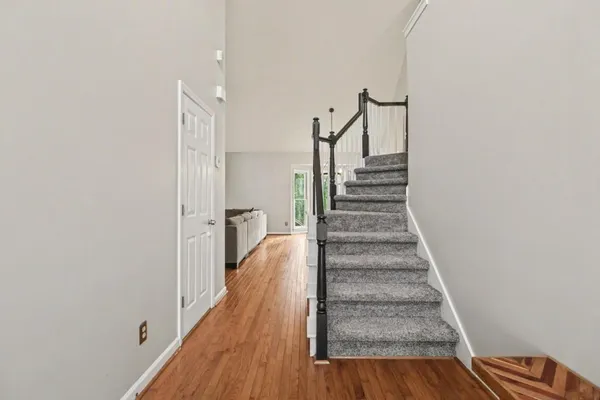 a view of a hallway with wooden floor and entryway