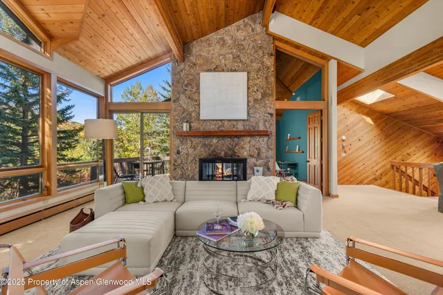 a living room with patio furniture and a large window