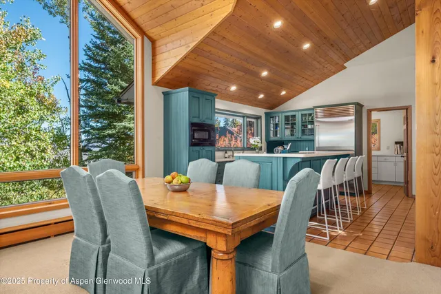 a kitchen with stainless steel appliances granite countertop a sink a stove and refrigerator