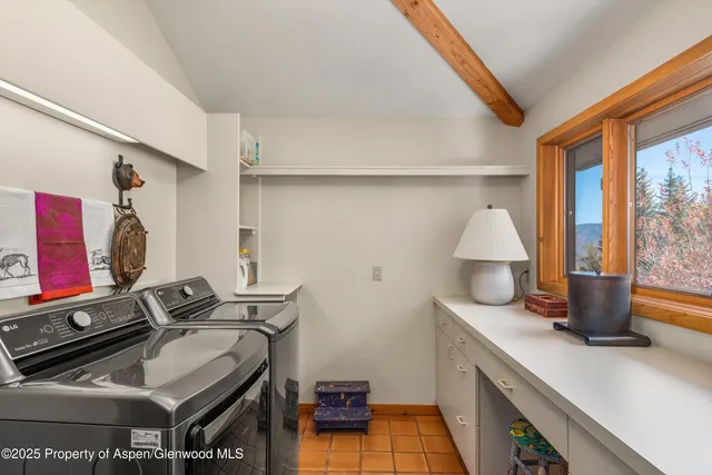 a living room with furniture a rug and a large window