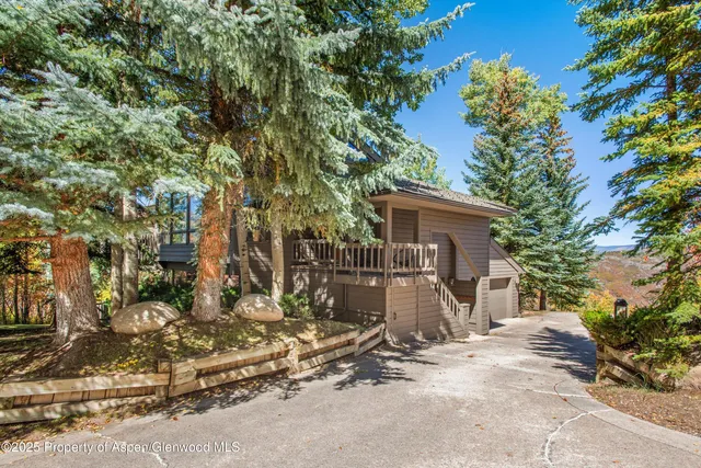 a view of a house with a tree in the background