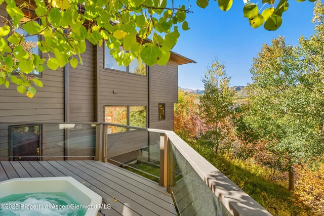 a bed sitting in a bedroom next to a large window