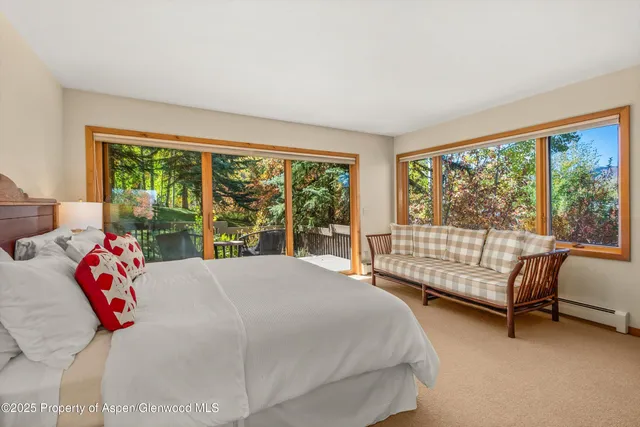a bedroom with a large bed and a large window