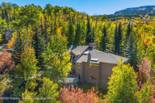 a view of a house with a yard and mountain