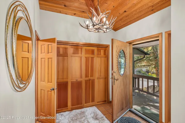 a living room with fireplace furniture and a large window