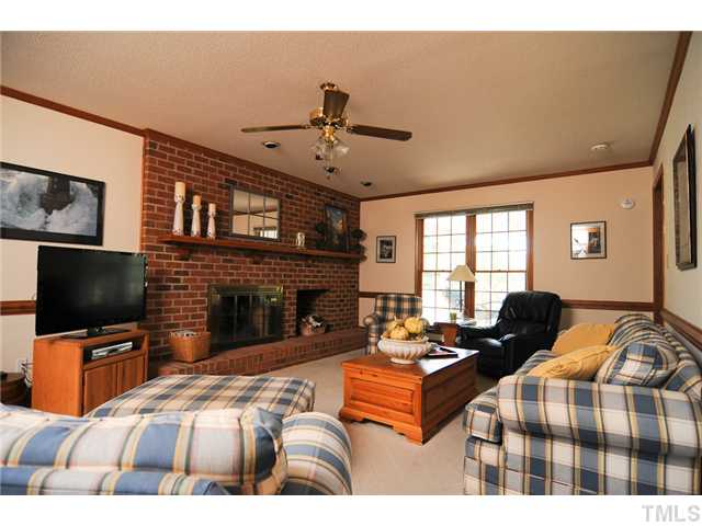 4018 Swarthmore Road Durham, NC 27707 - Photo 3 of 21 The family room offers a charming fireplace with brick hearth.