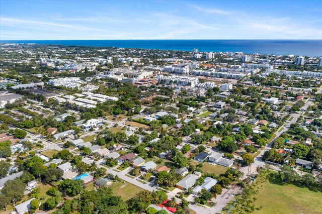 an aerial view of residential houses with city view