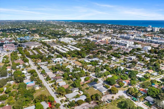 an aerial view of residential houses with city view